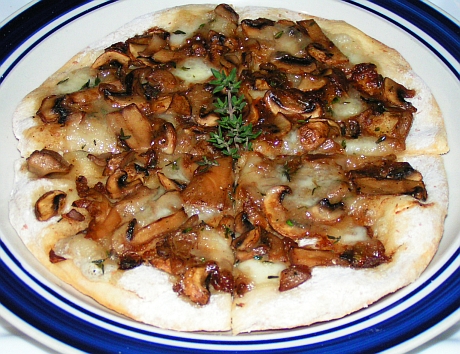 Thin crust pizza with mushrooms and goat cheese